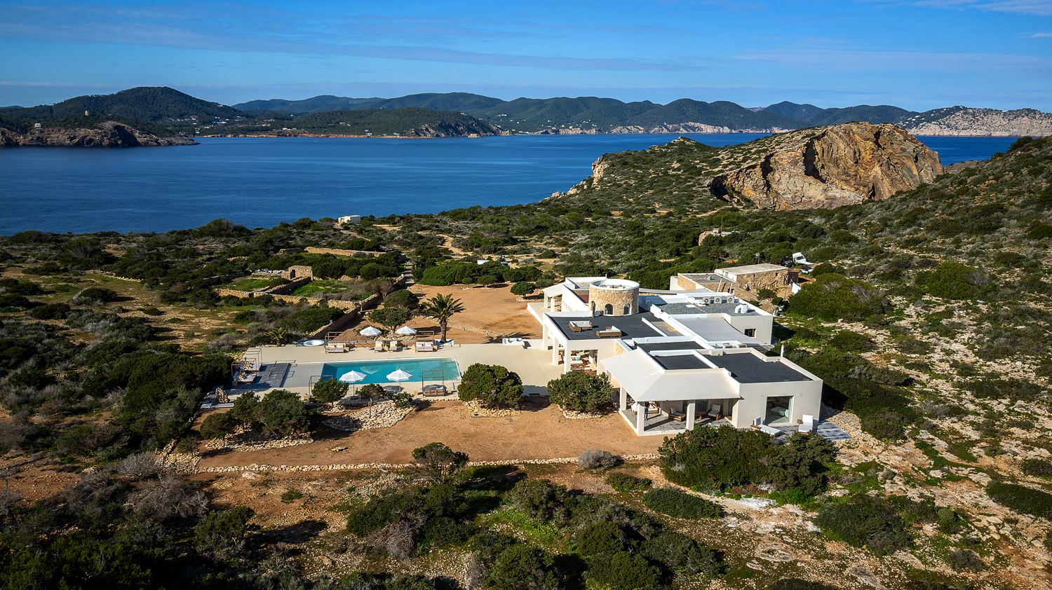 Aerial view of Tagomago Private Island near Ibiza, featuring the luxury five-bedroom villa and private jetty for HNWI events and exclusive corporate retreats.
